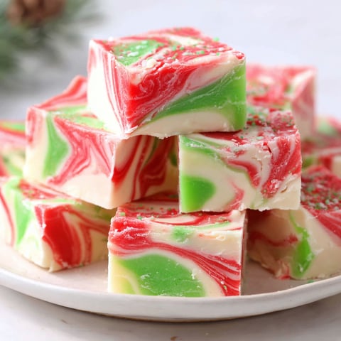 A stack of Christmas fudge on a plate.