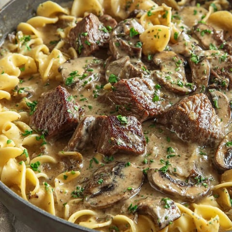 A delicious beef stroganoff with mushrooms and noodles.