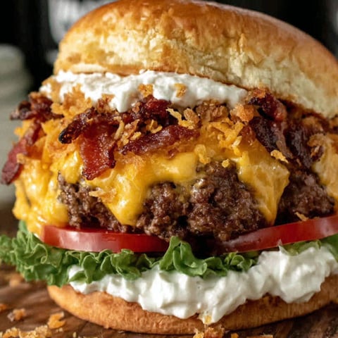 A large burger with bacon and cheese.