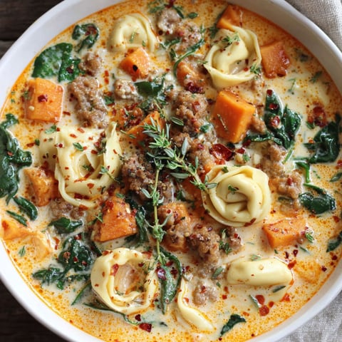 A bowl of creamy sausage tortellini soup.