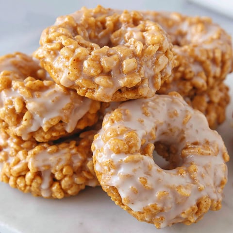 A stack of pumpkin rice krispie donuts.