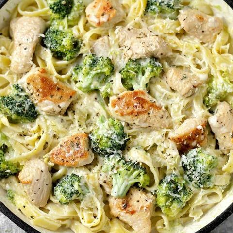 A bowl of chicken and broccoli alfredo.