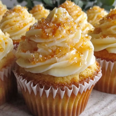 A close up of a cornbread cupcake with honey butter frosting.