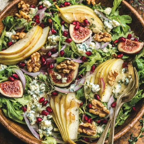 A bowl of salad with pears, walnuts, and blue cheese.