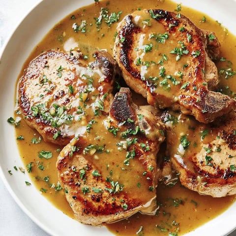 A plate of pork chops with honey mustard sauce.