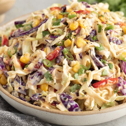 A bowl of taco coleslaw with various vegetables.