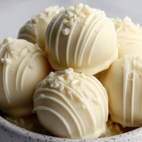 A bowl of white chocolate truffles.