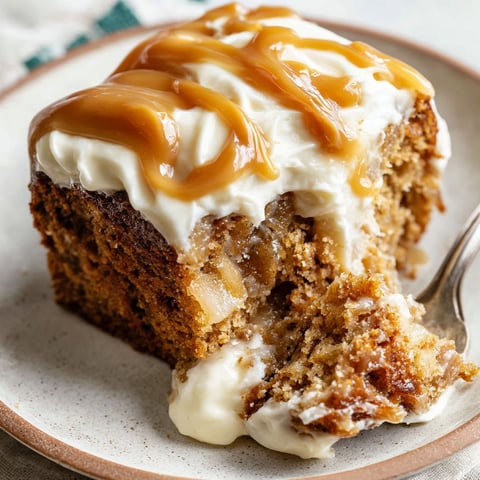 A slice of apple spice cake with salted caramel cream cheese frosting.