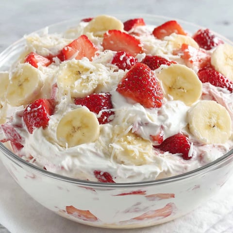 A bowl of strawberry banana cheesecake salad.