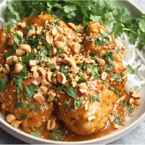 A bowl of slow cooker Thai peanut chicken.