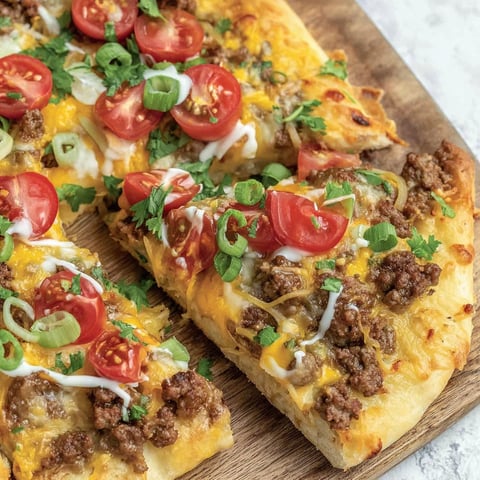 A slice of pizza with tomatoes and cheese.