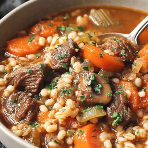 A bowl of hearty beef and barley soup.