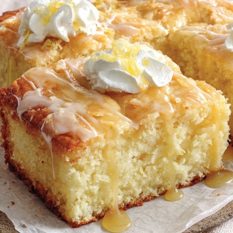 A slice of butter cake with white icing.