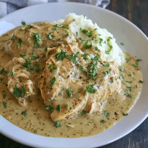 A plate of chicken and potatoes.